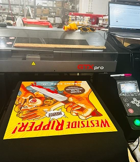 Black color printed t-shirt in DTG printing machine
